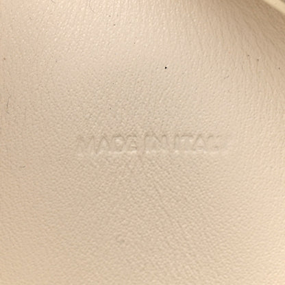 Light rice cream leather surface with faint embossed branding