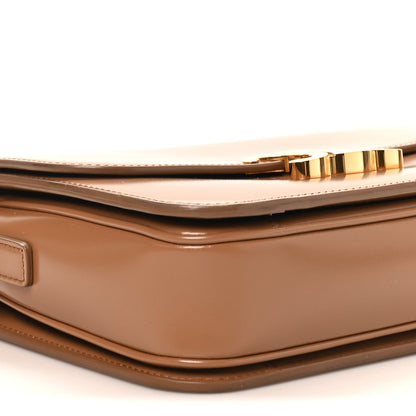 Bronze flap and top seam with gold-tone zipper trim