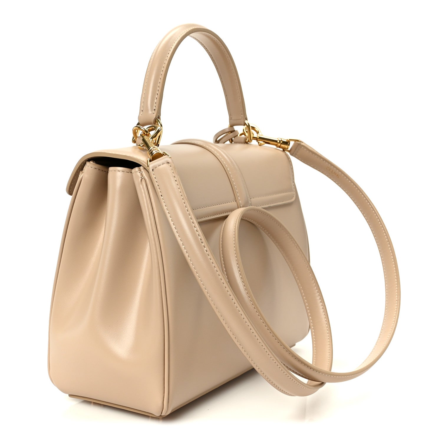 Small nude satchel bag with top handles, crossbody strap, and front flap closure