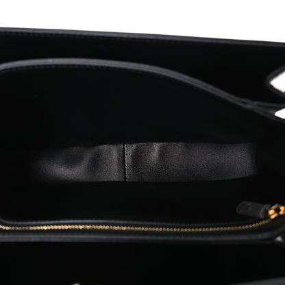 Shiny calfskin medium shoulder bag interior view with black lining and top zipper