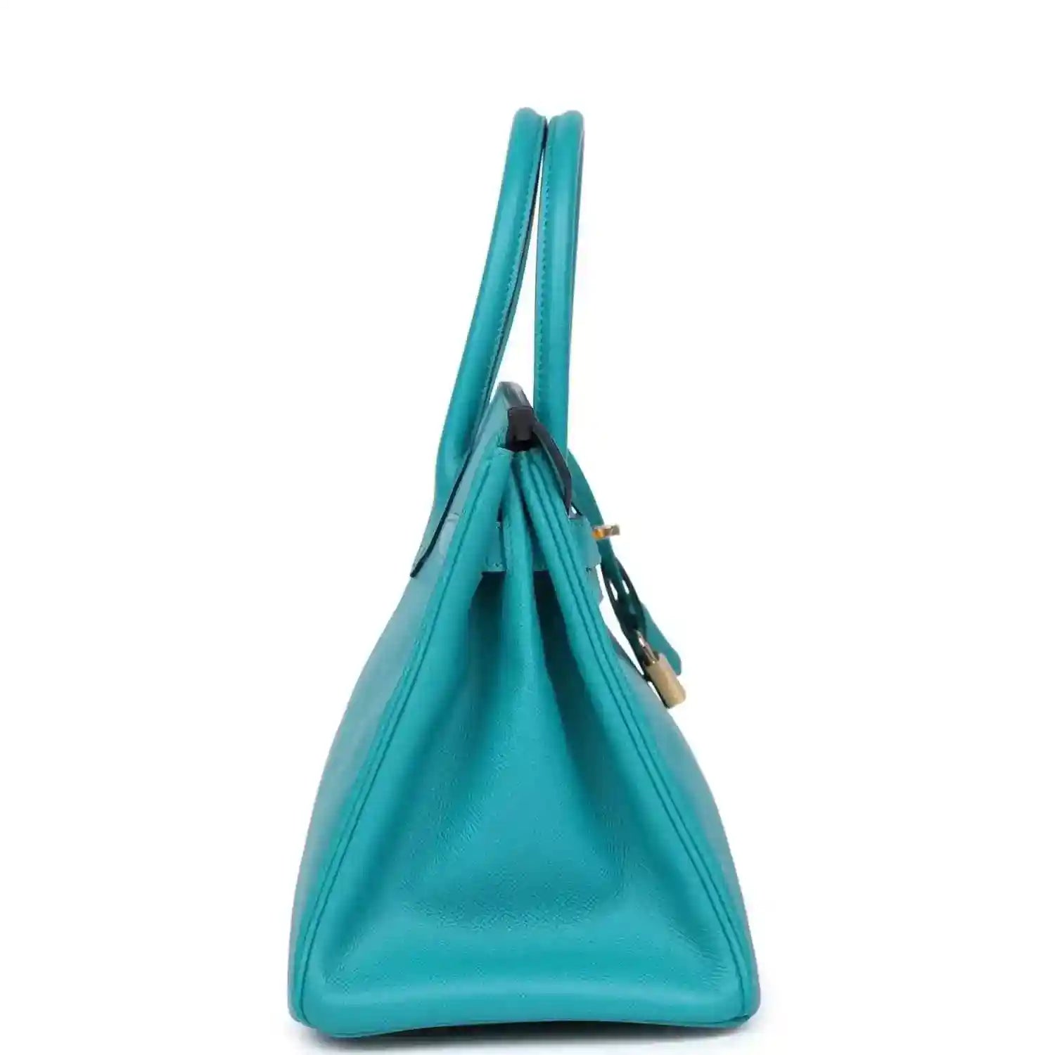 Elegant turquoise leather handbag with gold accents, timeless and sophisticated design