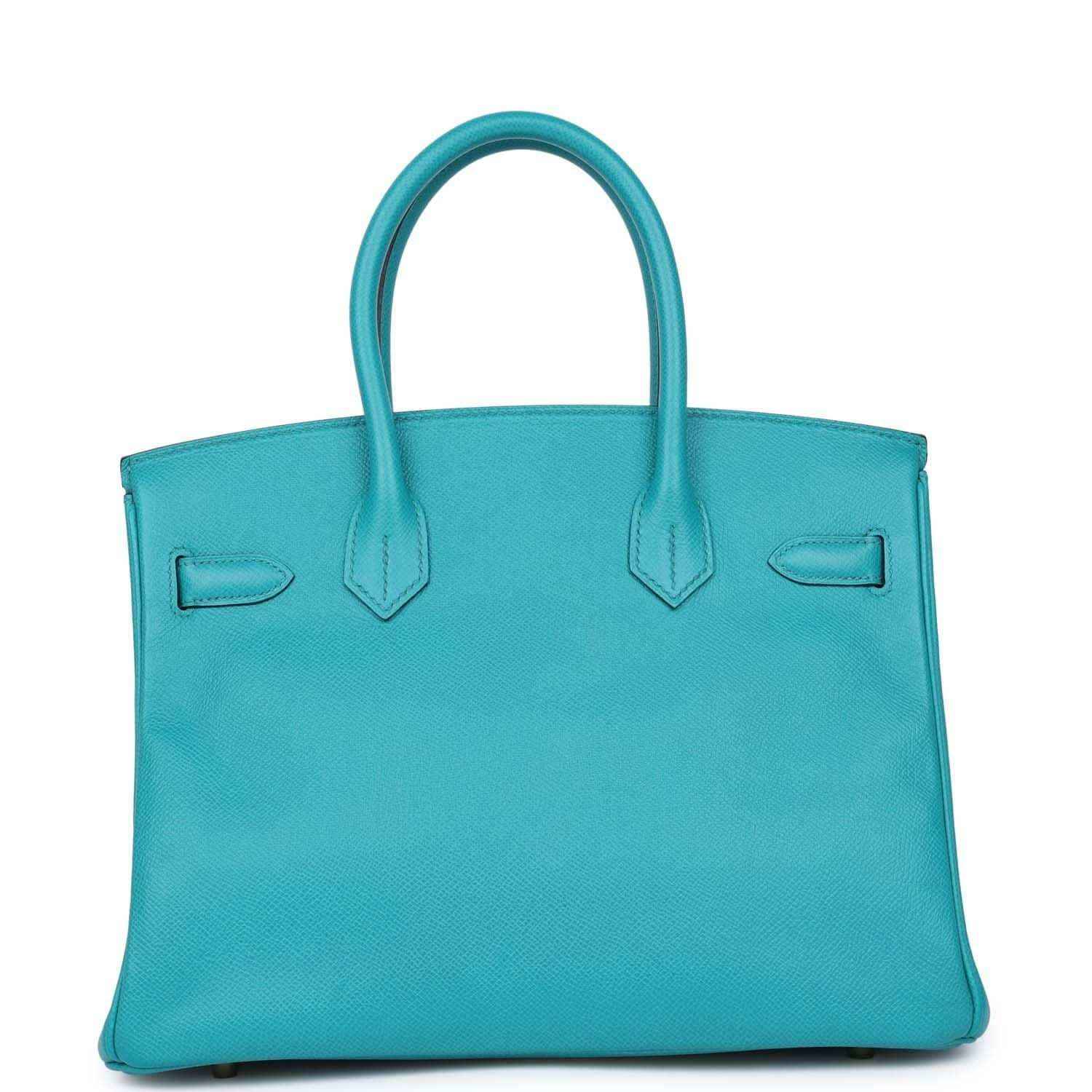 Elegant turquoise leather tote bag with timeless, sophisticated design and refined details.