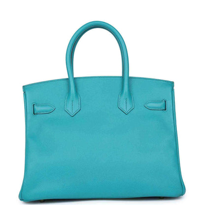 Elegant turquoise leather tote bag with timeless, sophisticated design and refined details.