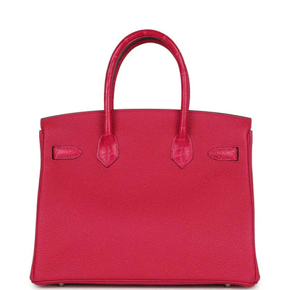 Timeless, elegant red leather tote handbag with structured shape and refined detailing.