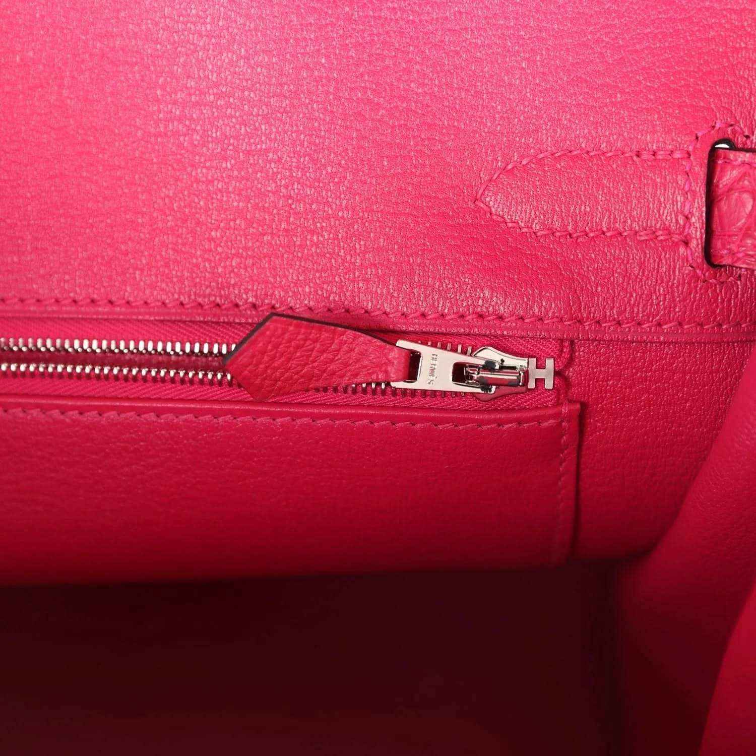 Elegant pink leather handbag interior with silver zipper, showcasing timeless sophistication