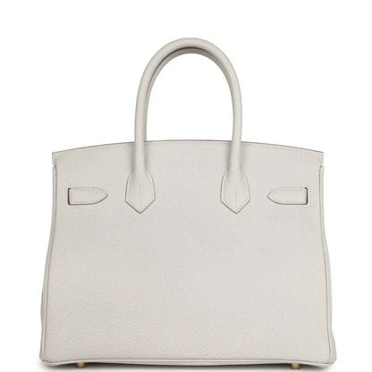 Timeless, sophisticated white leather tote handbag with elegant structured design.