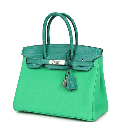 Elegant green leather handbag with crocodile texture accents and silver hardware