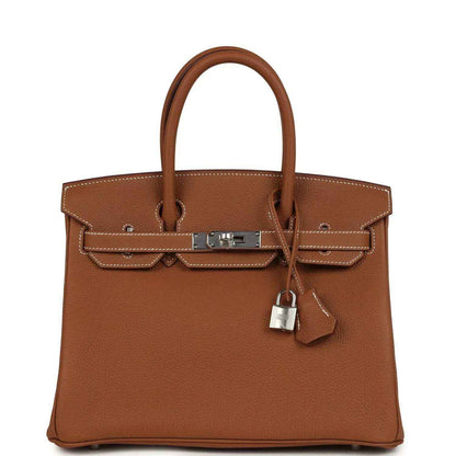 Timeless, sophisticated brown leather handbag with elegant hardware and structured silhouette.