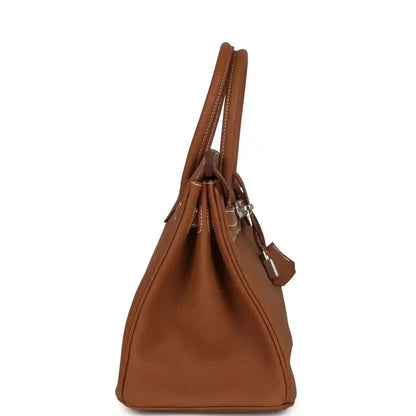 Elegant tan leather handbag with silver hardware and refined stitching, side view