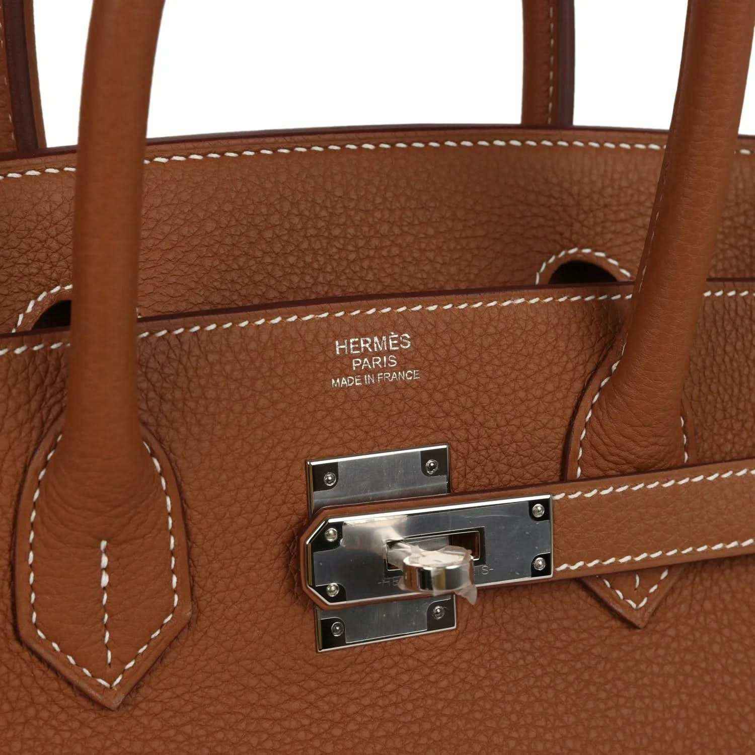 Timeless brown leather handbag with silver hardware, elegant stitching, and sophisticated design.