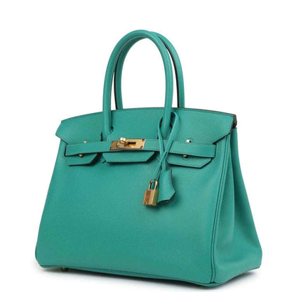 Elegant teal leather tote handbag with gold hardware, showcasing timeless, sophisticated style.