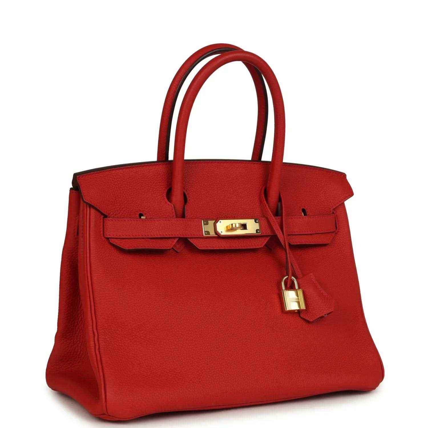 Timeless red leather handbag with gold hardware, elegant top handles, and sophisticated design.
