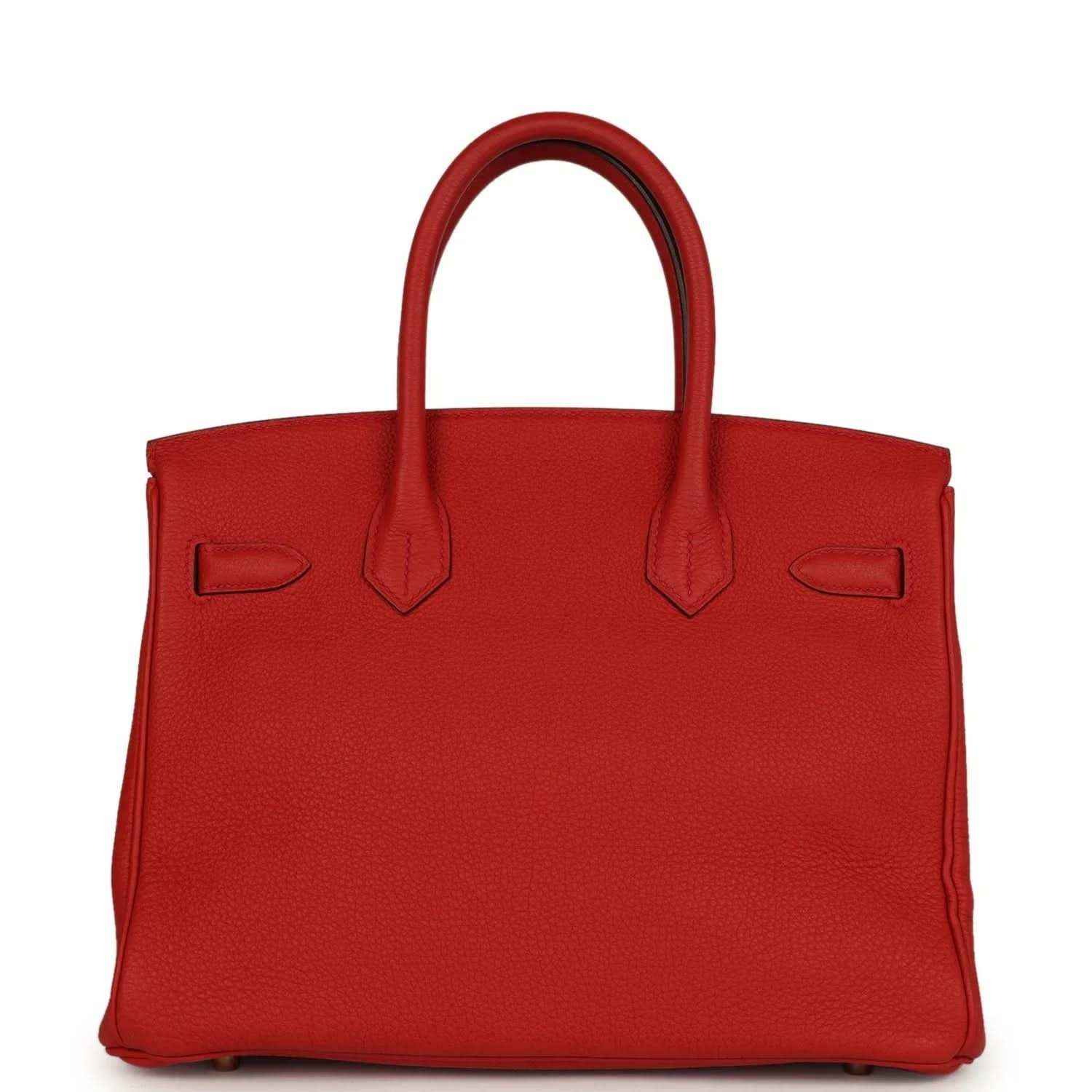 Timeless red leather handbag for women with elegant, sophisticated design and top handles.