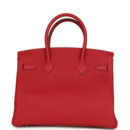 Elegant red leather handbag with top handles, timeless and sophisticated design