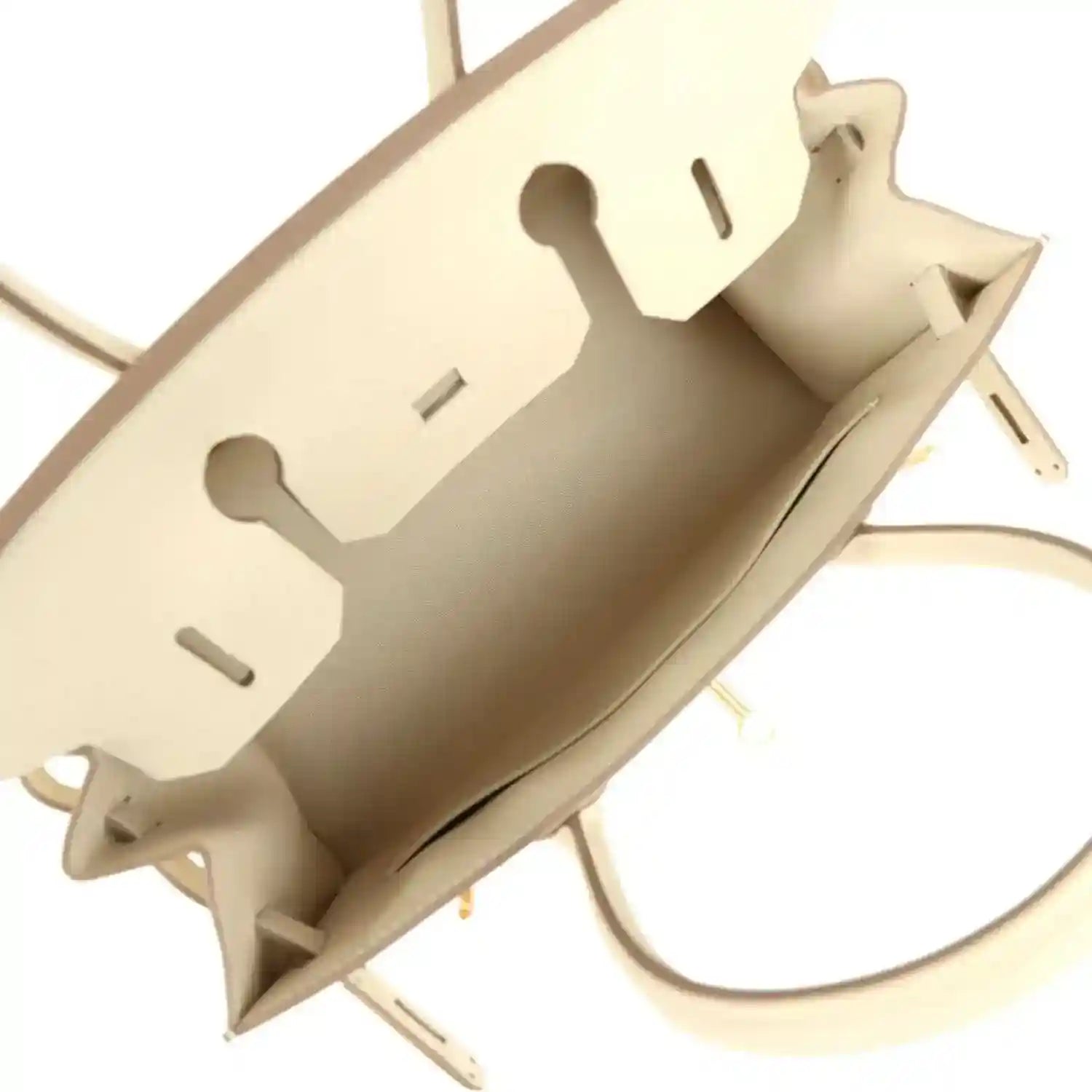 Open leather handbag interior with light lining and gold hardware, light neutral.