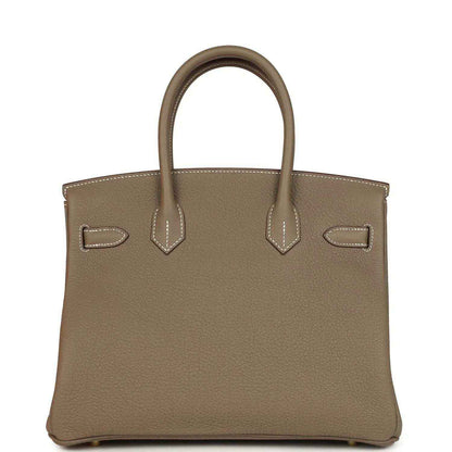Timeless taupe leather handbag with elegant top handles and sophisticated stitching detail