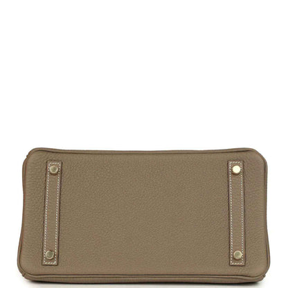 Timeless taupe leather handbag base with elegant gold-tone feet and refined stitching details.