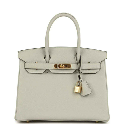 Elegant light grey leather handbag with gold hardware and a timeless, sophisticated silhouette.