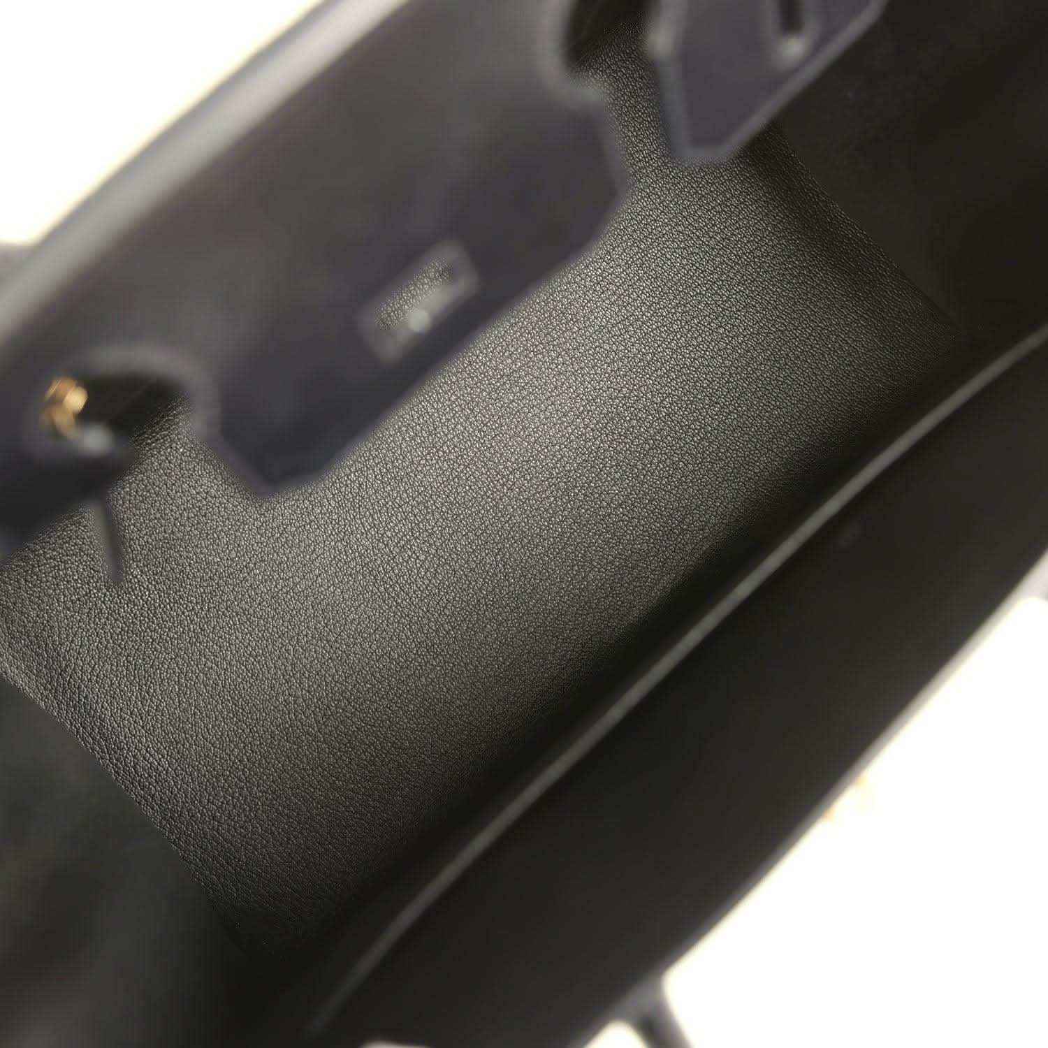 Birkin handbag close-up of black leather texture near edge stitching and hardware