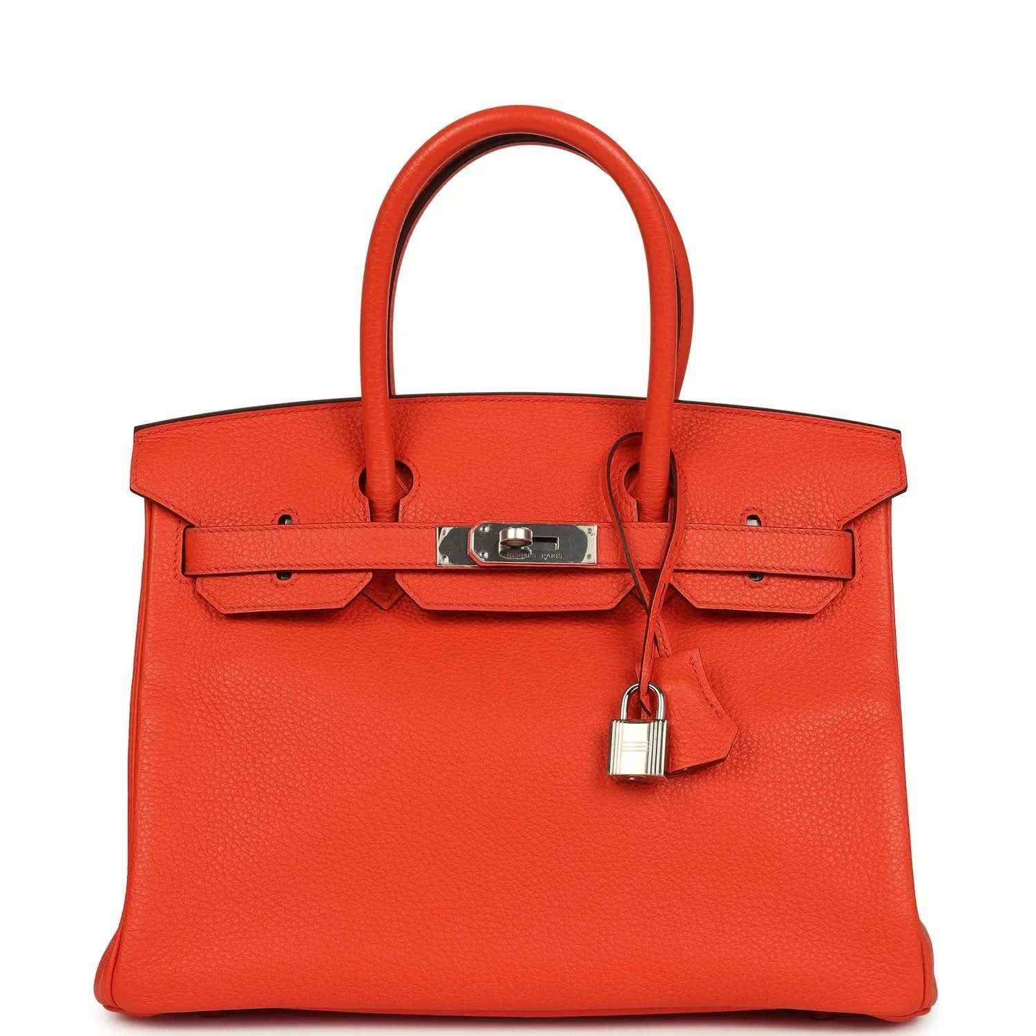 Timeless, elegant orange leather handbag with silver hardware and a sophisticated silhouette.