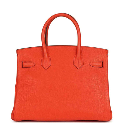 Timeless, elegant orange leather handbag with refined texture and sophisticated silhouette.