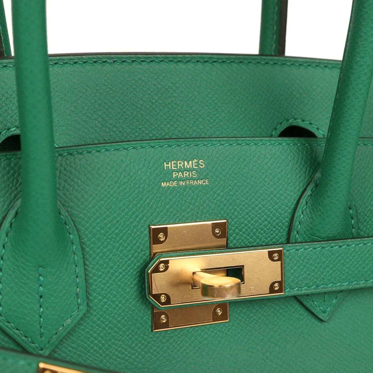 Hermes handbag interior stamp area with gold lock hardware on green leather