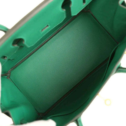 Green leather handbag interior view with top opening and visible front lining
