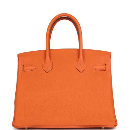 Timeless orange leather handbag with elegant, structured silhouette and refined finish.