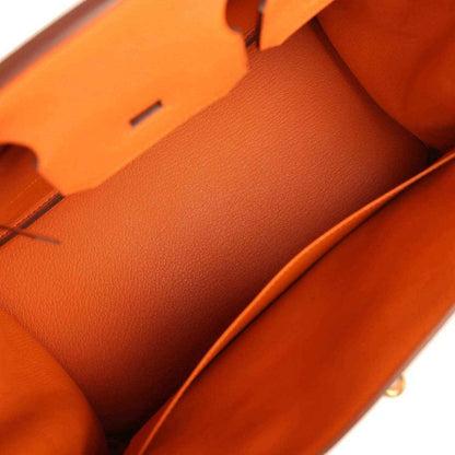 Timeless orange leather handbag interior with elegant, sophisticated design and smooth finish.