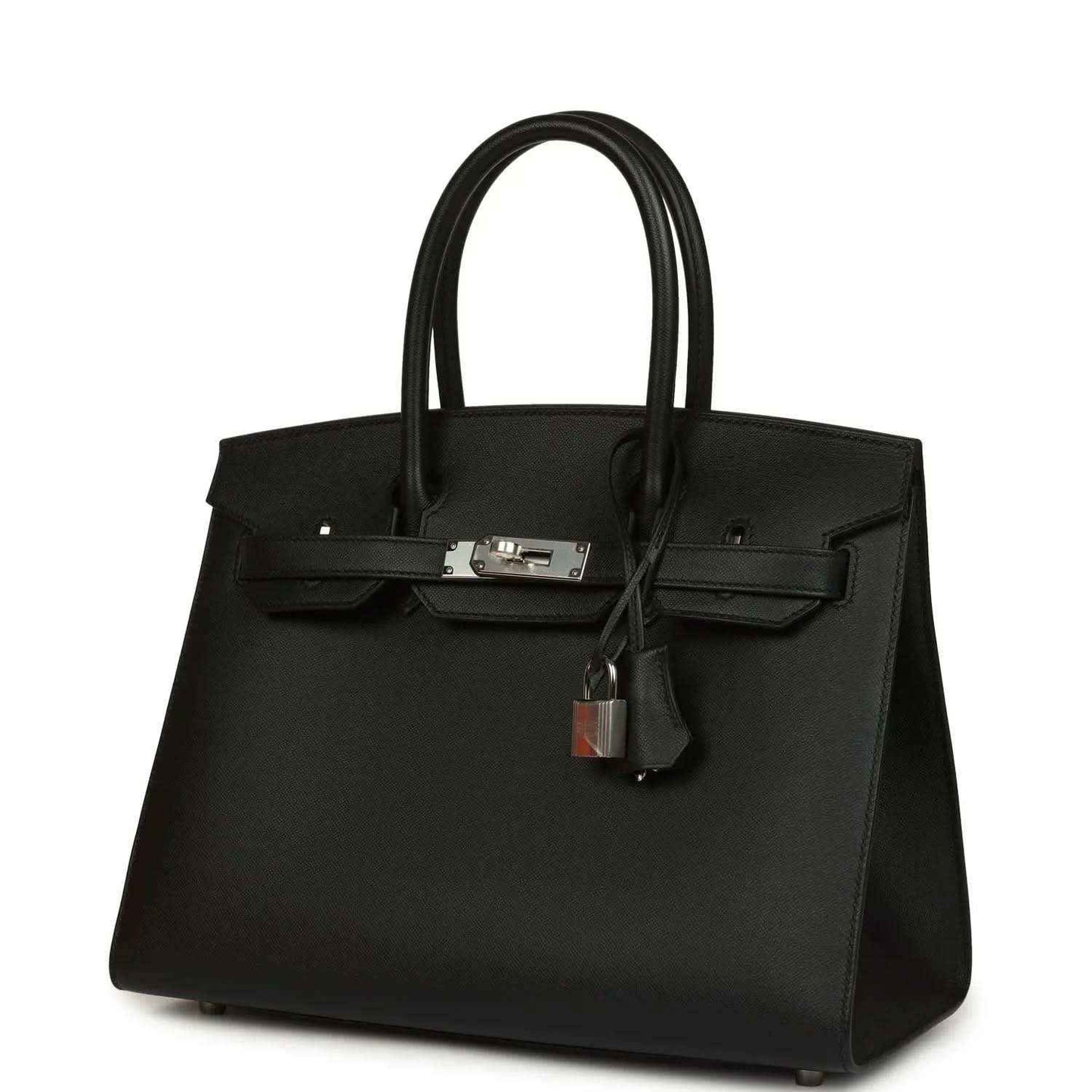 Black leather handbag with top handles, front flap, and hanging lock charm