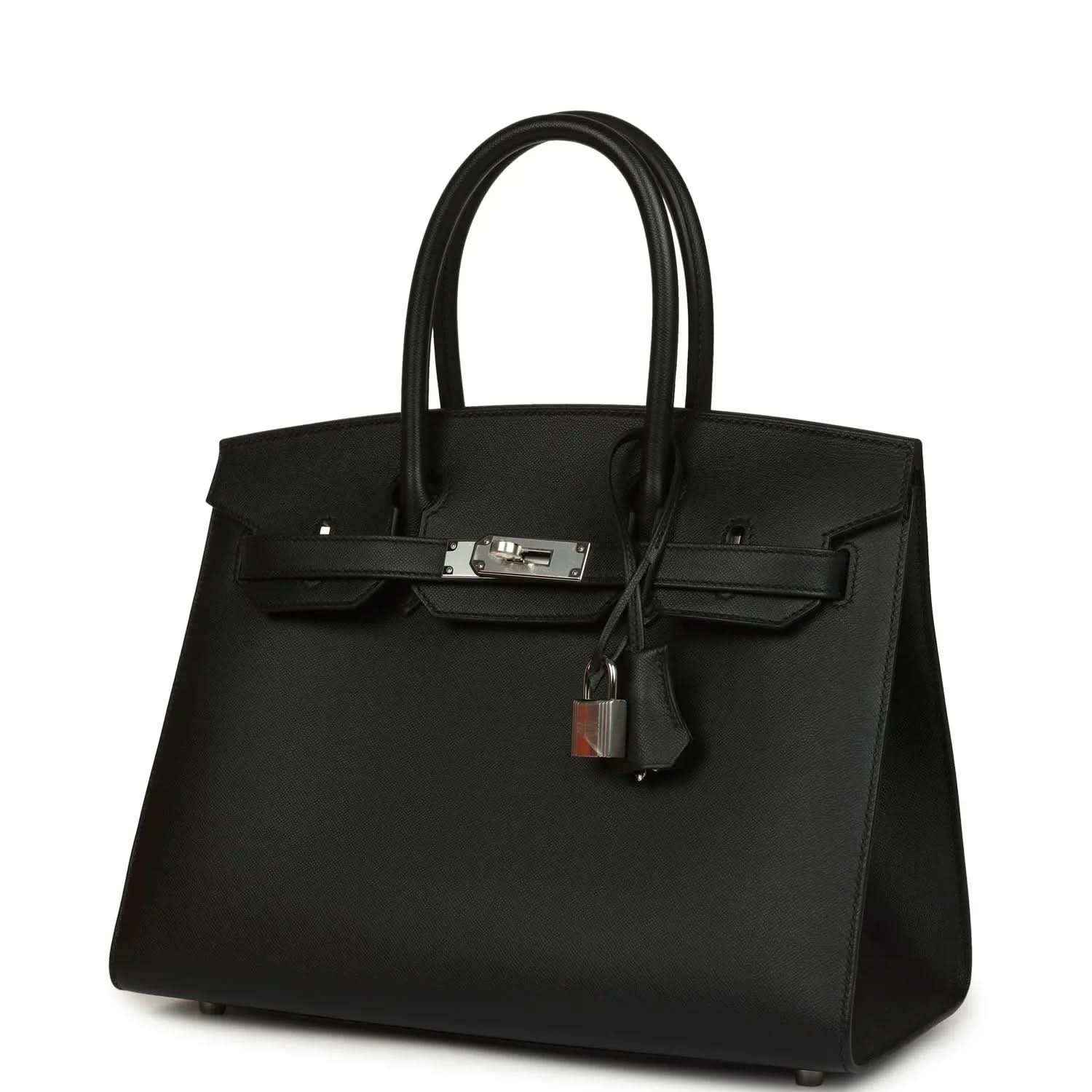 Black leather handbag with top handles, front flap, and hanging lock charm