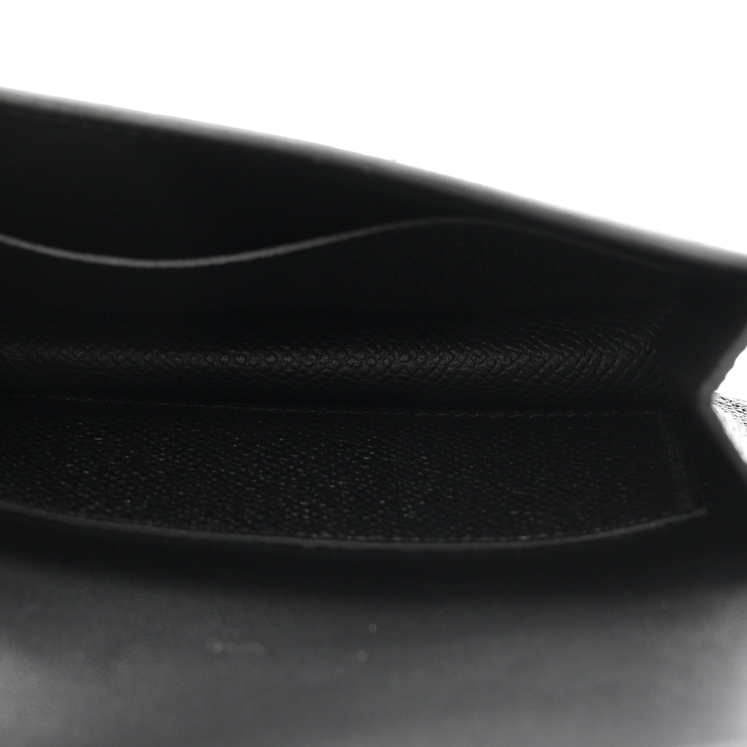 Black leather wallet interior with stitched edge and soft lining.