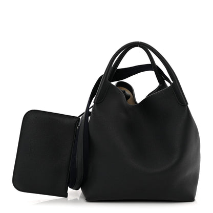 Large dark navy tote bag with grained finish, top handles, and side pocket