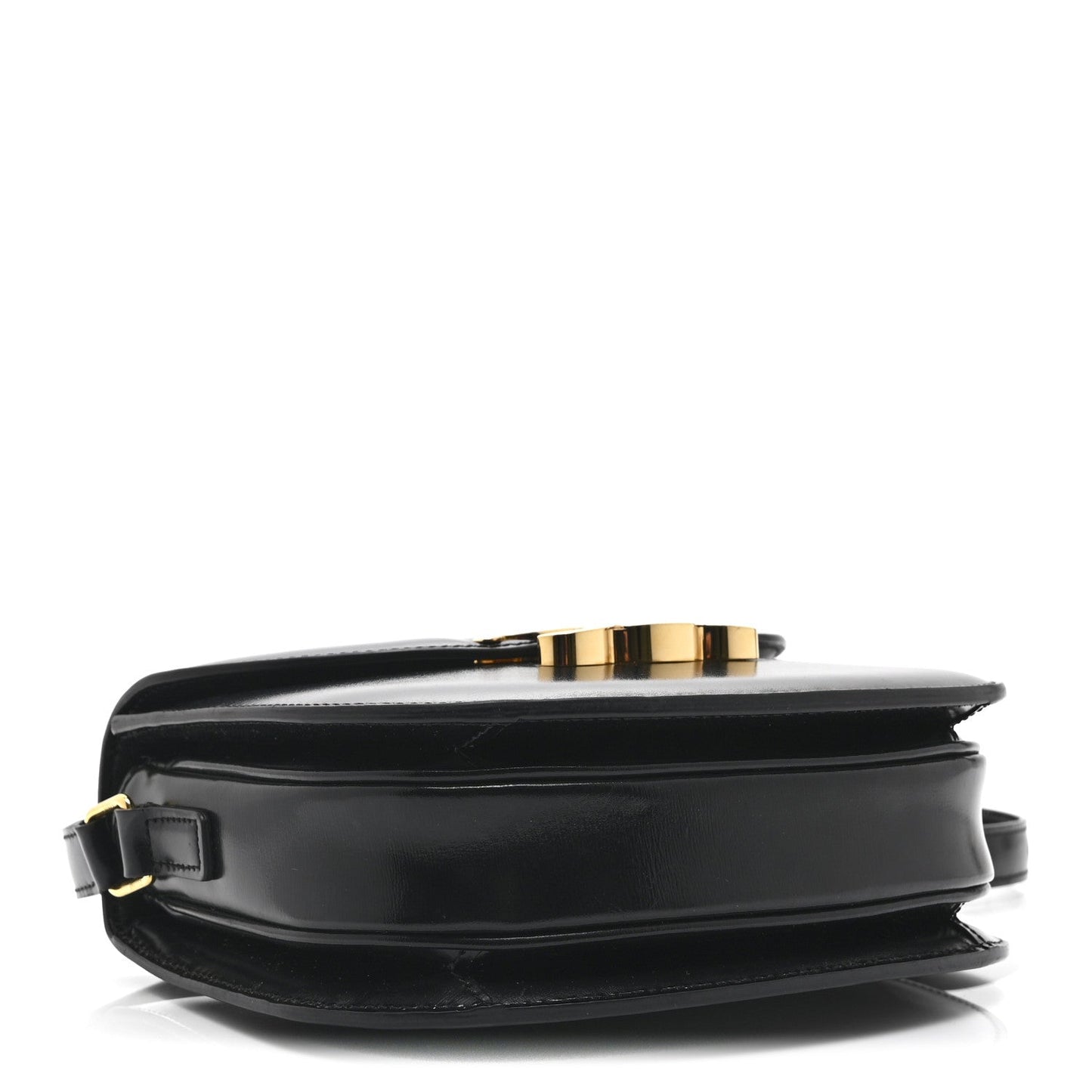 Black leather crossbody bag side view with gold-tone top clasp and handle loop