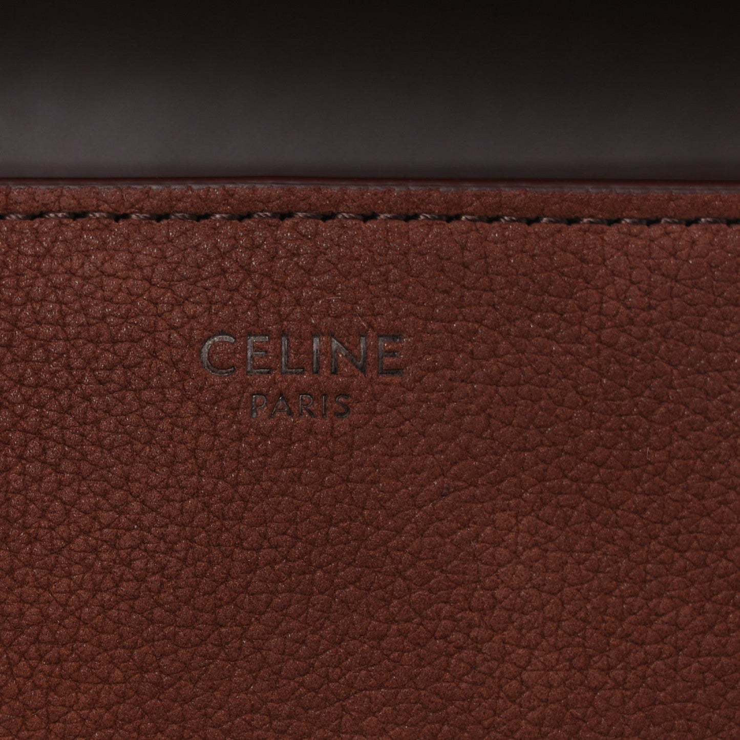 Brown grained leather panel with 'CELINE PARIS' stamp.
