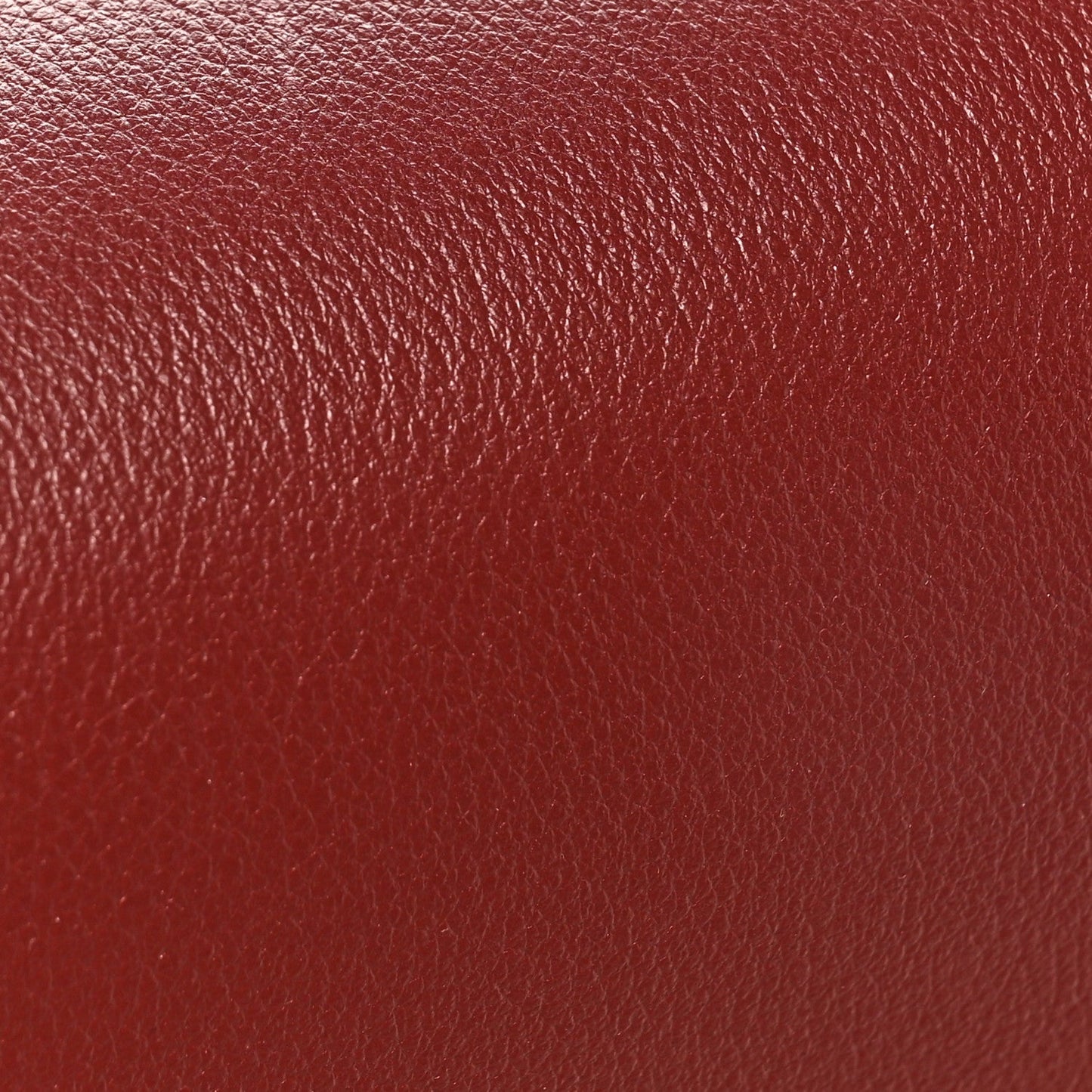 Light burgundy grained calfskin bag leather texture close-up