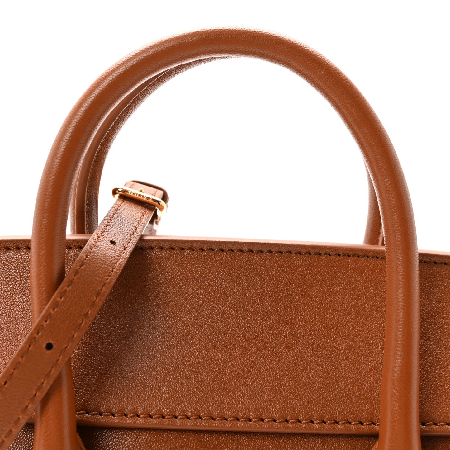 Tan leather tote handle attachment with small metal buckle