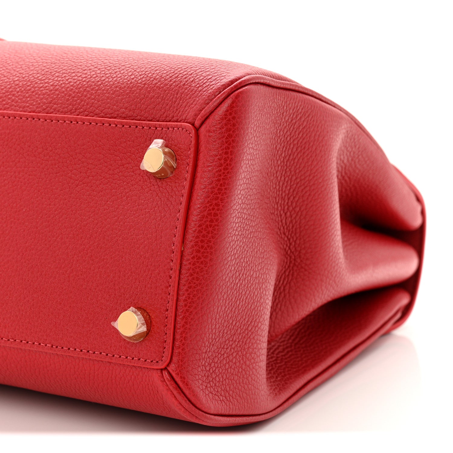 Red leather end panel with gold studs and curved opening