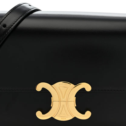 Black shiny leather flap bag with gold C logo medallion on front.