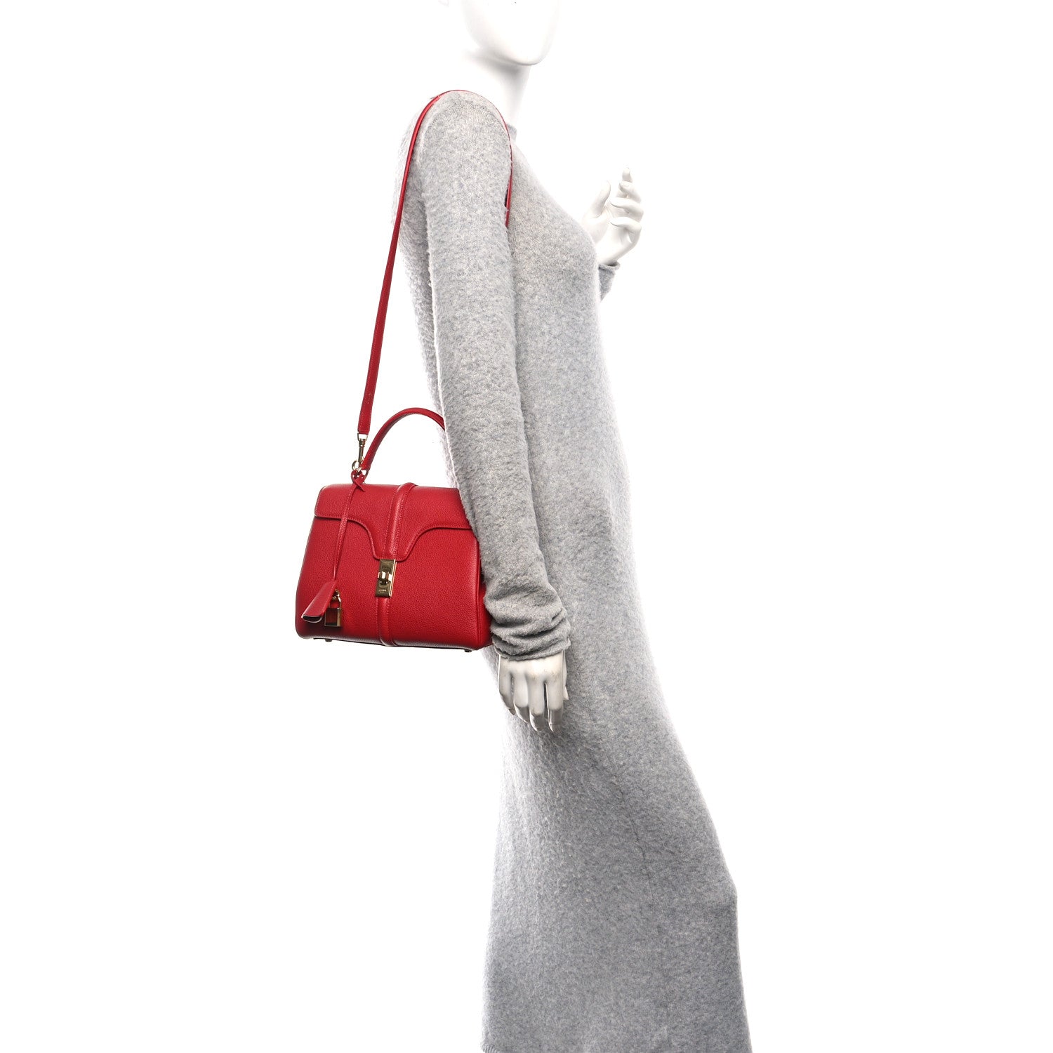 Celine small red top-handle bag worn crossbody with adjustable strap.
