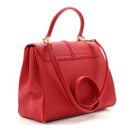 Red grained leather top-handle bag with curved strap and front flap lock