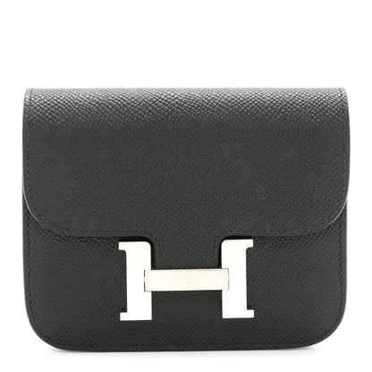 Black slim wallet with front H clasp in palladium-tone metal.