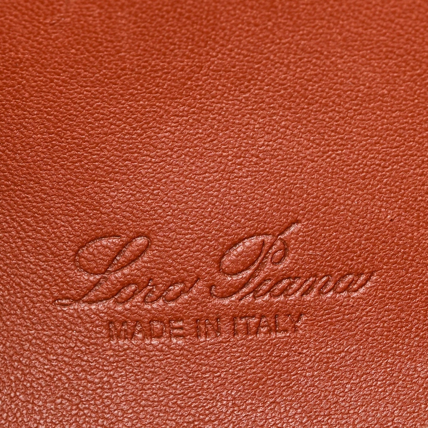 Embossed Loro Piana logo on grained calfskin pouch in brown