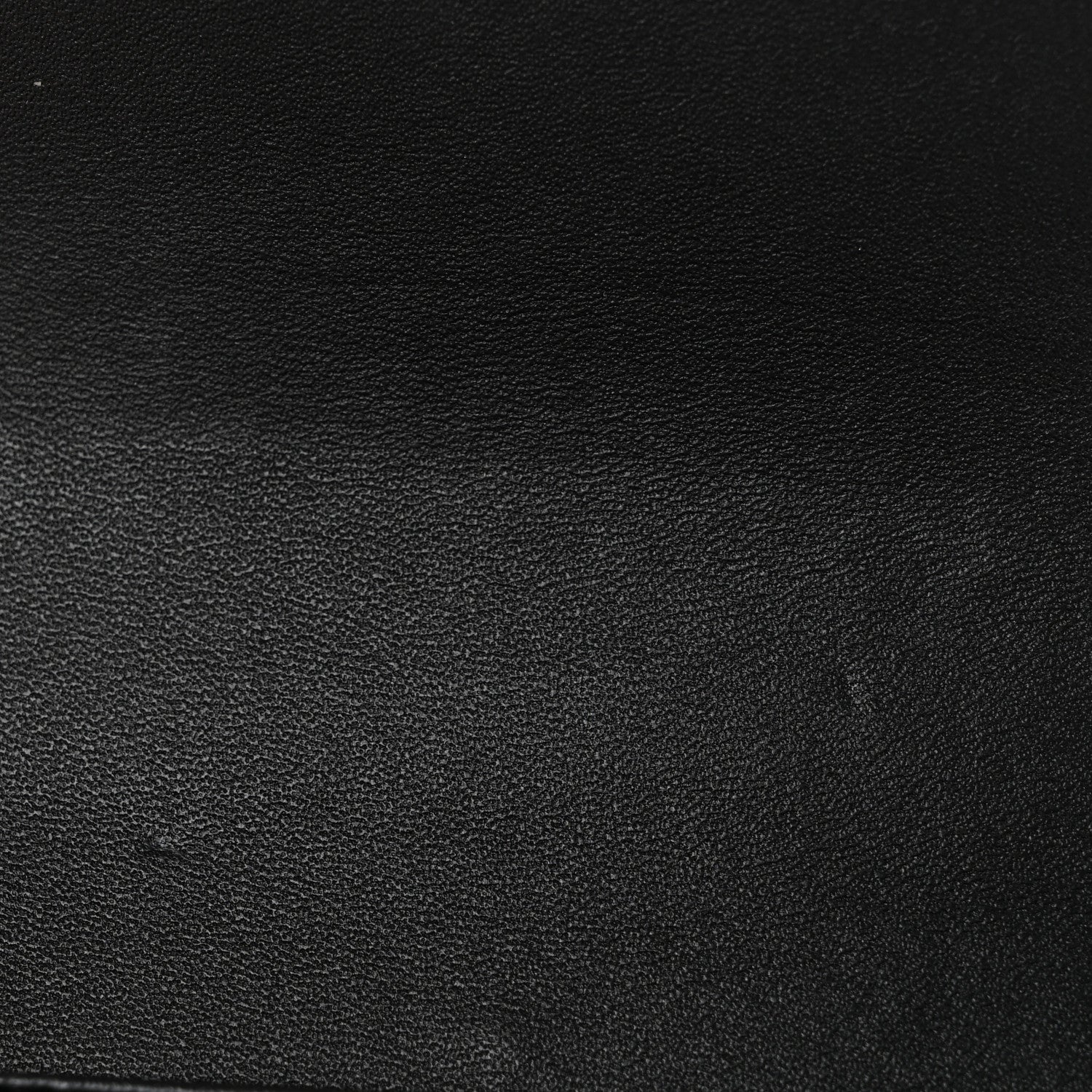 Black shiny calfskin leather texture close-up