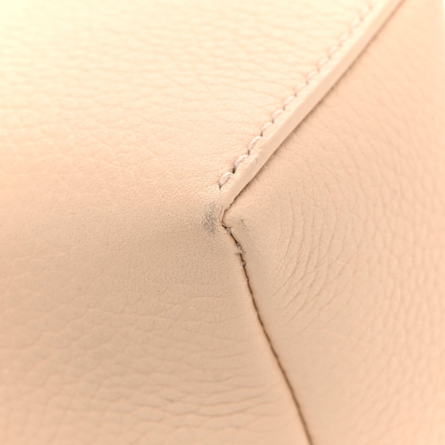 Cream leather pouch close-up of seam and stitching detail
