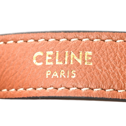 Tan leather strap trim with white contrast stitching and Celine Paris lettering