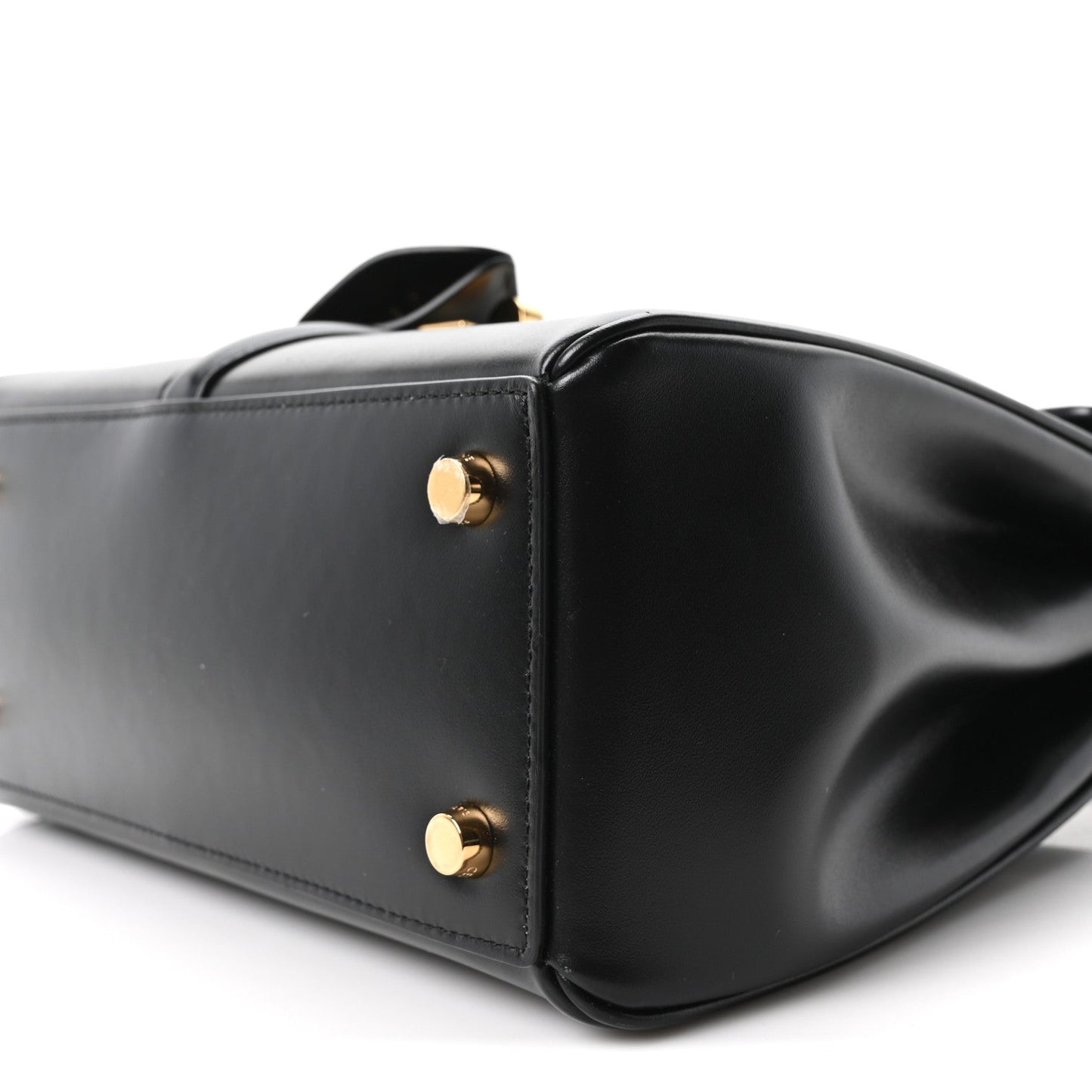 Celine mini bag close-up in black leather with round gold studs on side panel