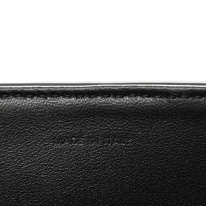 Black grained leather close-up with smooth edge seam detail