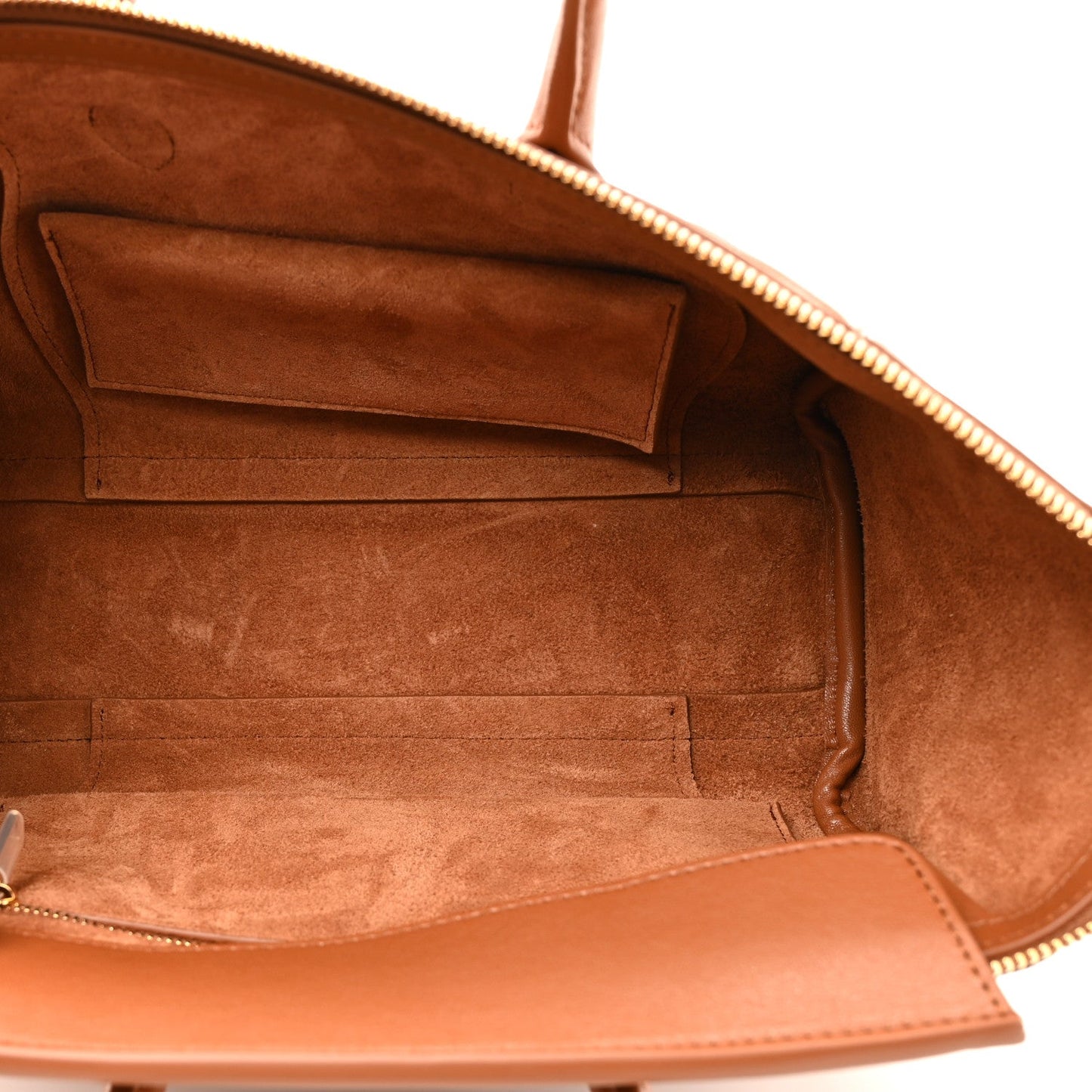 Tan leather handbag interior with zipper opening and suede-style lining.