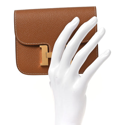 Constance slim wallet with gold-tone H clasp and front flap in textured tan leather